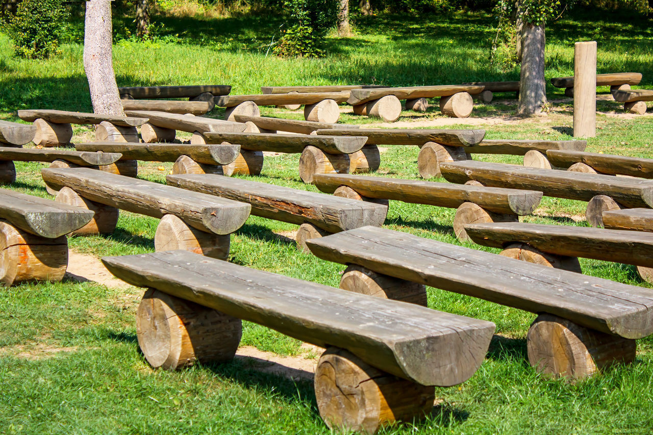 WOODEN BENCH ON FIELD