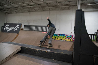 Full length of man skateboarding on skateboard