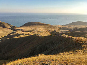 Scenic view of sea and mountains against sky