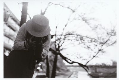 Woman standing on tree trunk