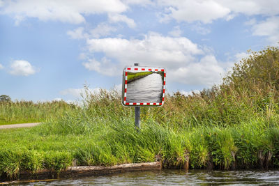 A mirror standing in a bend, on the edge of the channel, to observe the other side.