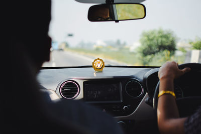 Rear view of man driving car