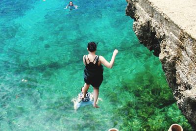 High angle view of woman swimming in sea