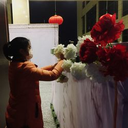 Midsection of man holding bouquet