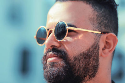 Close-up portrait of man wearing sunglasses