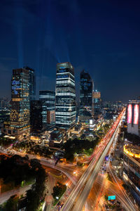 High angle view of illuminated buildings in city at night