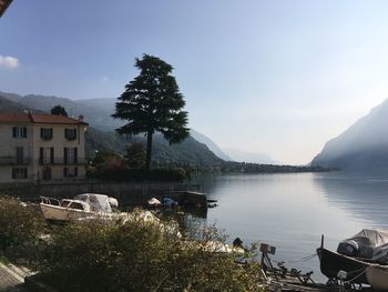 Scenic view of lake by buildings against sky