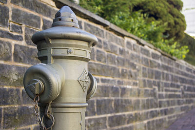 Close-up of fire hydrant against wall