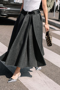 Low section of woman standing on street