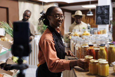 Side view of young woman standing in store
