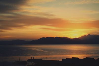 Scenic view of sea against romantic sky at sunset