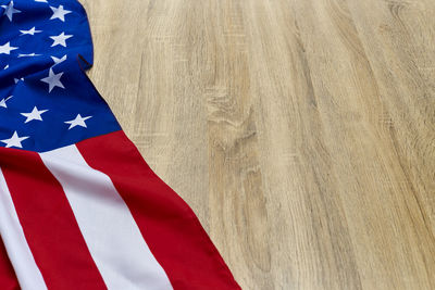 Close-up of american flag on wooden floor