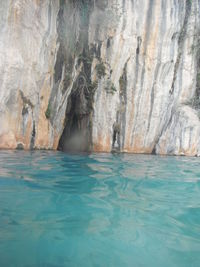 Surface level of rocky shore against blue sea