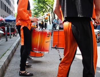 Rear view of people walking on street in city