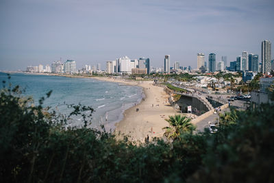 High angle view of buildings by sea against sky