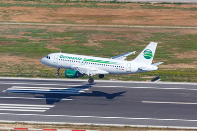 High angle view of airplane on airport runway