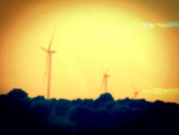 Silhouette of wind turbines at sunset