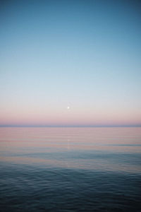Scenic view of sea against clear sky at sunset
