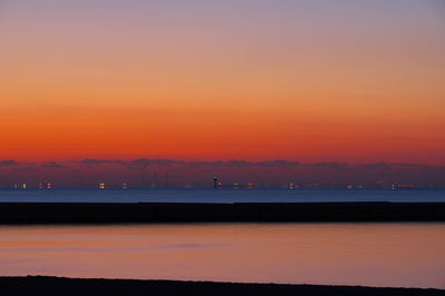 Scenic view of sea against romantic sky at sunset