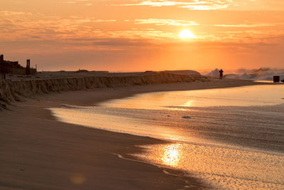 Scenic view of beach against sky during sunset