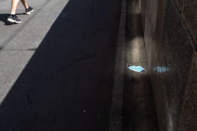Low section of person walking on road