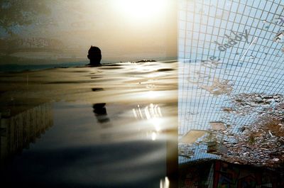 Close-up of silhouette swimming in pool