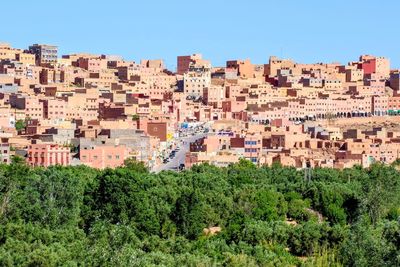 Buildings in city against clear sky