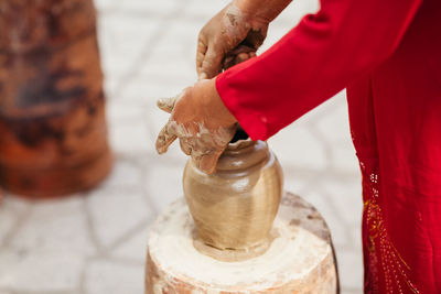 Midsection of woman making pottery