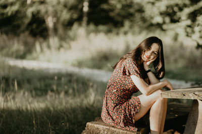 Young woman sitting on field