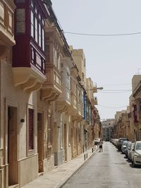 Narrow street amidst buildings against sky