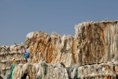 Man standing on rocks against clear sky