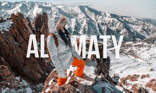 Woman with umbrella on snowcapped mountains