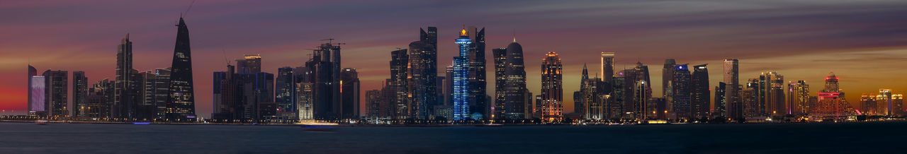 Illuminated buildings in city at night. doha skyline
