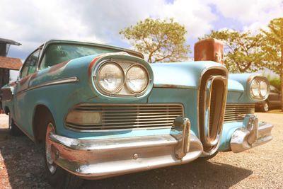 Abandoned vintage car against sky