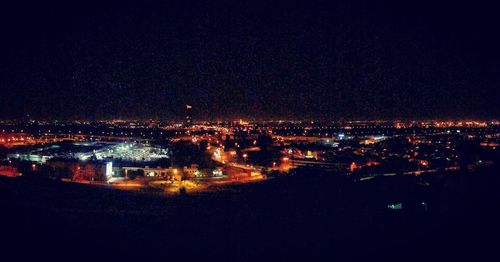 High angle view of illuminated buildings in city at night