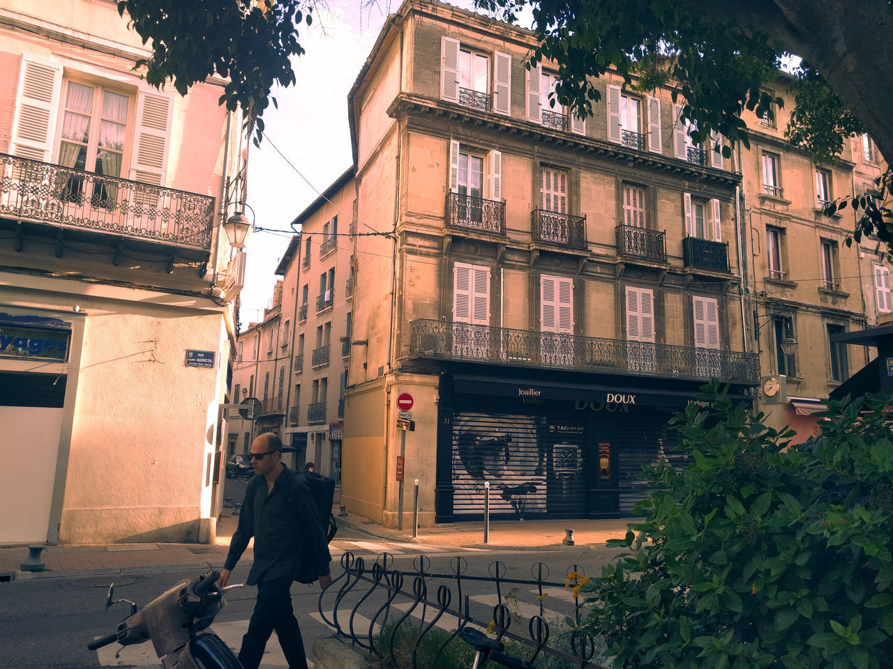 PEOPLE WALKING ON STREET AMIDST BUILDINGS