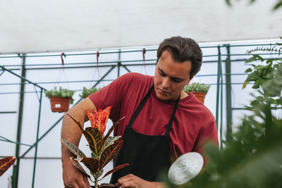 Man standing in greenhouse