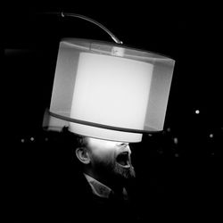 Man with illuminated lamp shade