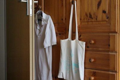 Shopping bag hanging on cabinet at home