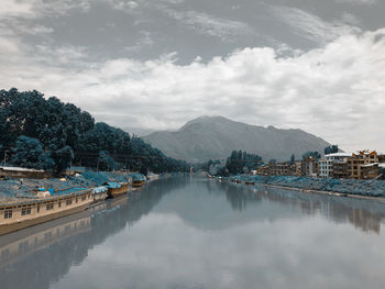 Panoramic view of buildings and mountains against sky