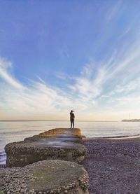 Standing over the beach under the dramatic blue sky