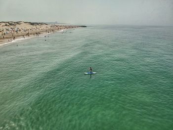 High angle view of people in sea against sky