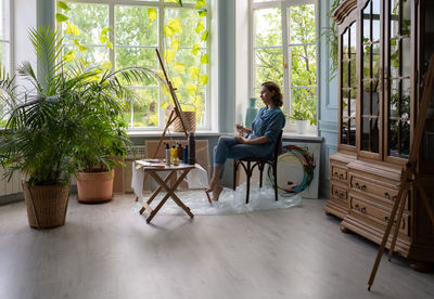 Creative woman admiring artwork in studio