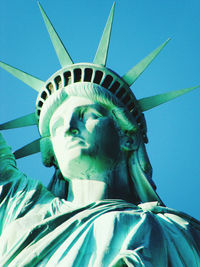 Low angle view of statue against blue sky