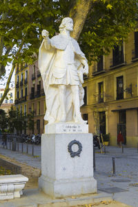 Statue against trees in city