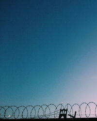 Metal structure against clear blue sky