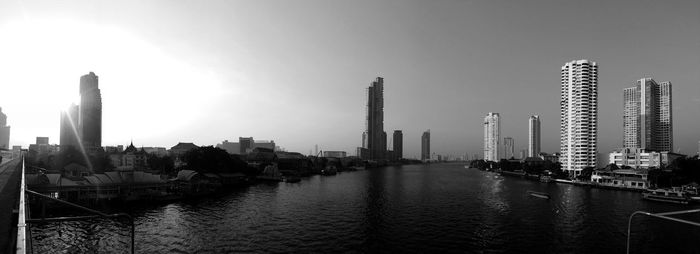 Panoramic view of river and buildings against sky