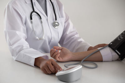 Midsection of person wearing high angle view of hands on table