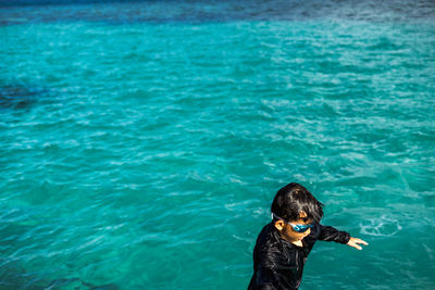 High angle view of boy swimming in sea