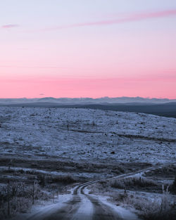 Scenic view of land against sky during sunset